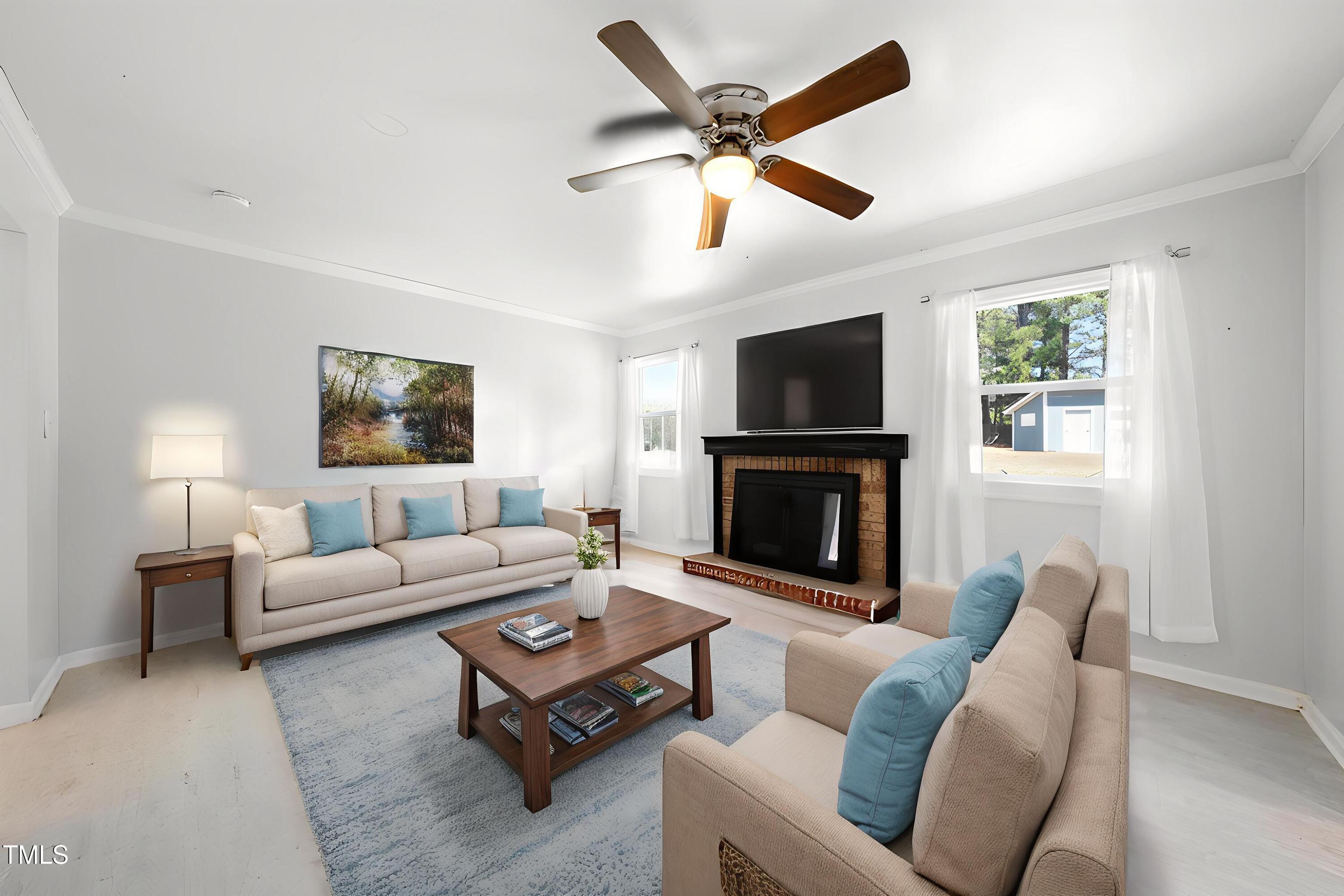 916 Clayton Road Durham, NC 27703 - Photo 2 of 32 a living room with furniture a fireplace and a flat screen tv