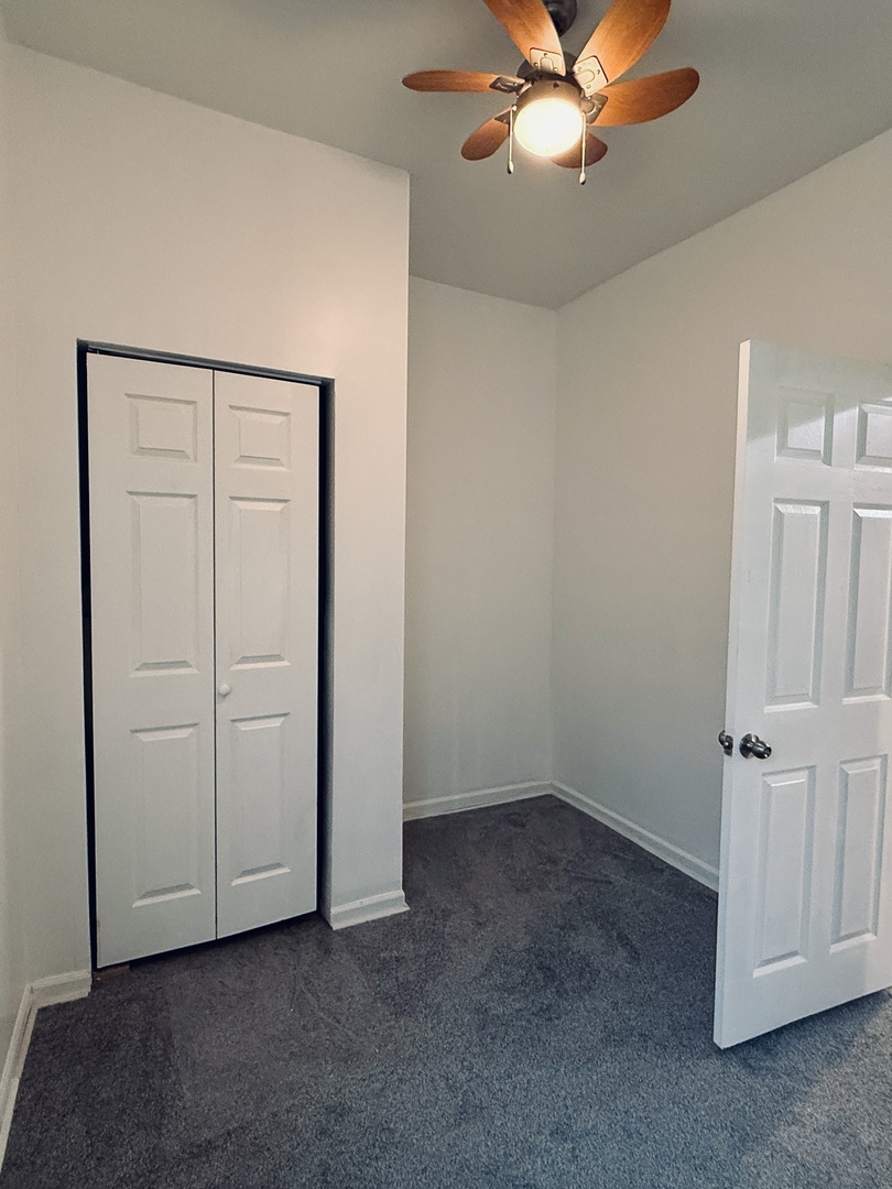 11725 South Morgan Street Chicago, IL 60643 - Photo 22 of 40 an empty room with closet and a chandelier fan