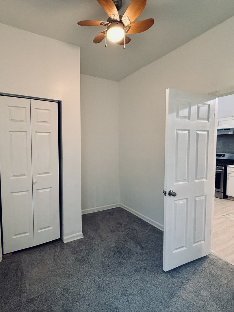 11725 South Morgan Street Chicago, IL 60643 - Photo 26 of 40 an empty room with a ceiling fan