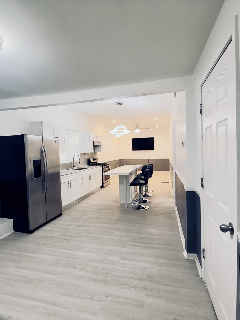 11725 South Morgan Street Chicago, IL 60643 - Photo 29 of 40 a large white kitchen with cabinets and stainless steel appliances