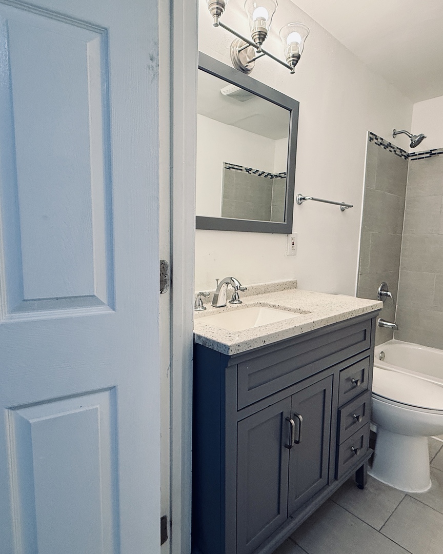 11725 South Morgan Street Chicago, IL 60643 - Photo 30 of 40 a bathroom with a granite countertop toilet sink and mirror