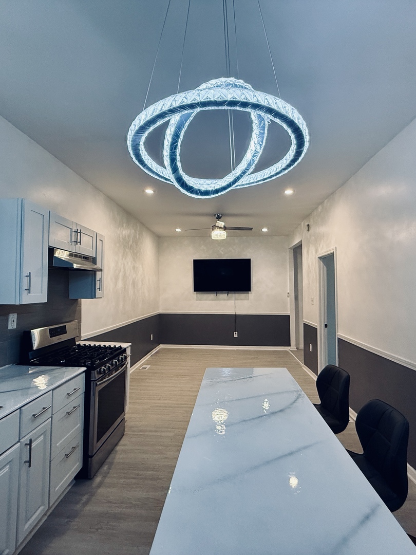 11725 South Morgan Street Chicago, IL 60643 - Photo 3 of 40 a kitchen with a sink and a stove with wooden floor