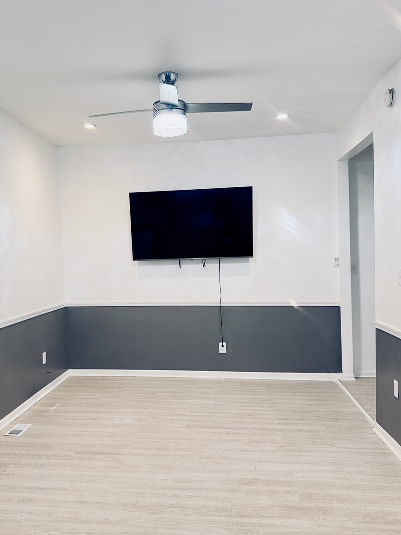 11725 South Morgan Street Chicago, IL 60643 - Photo 8 of 40 a view of room with a ceiling fan and wooden floor