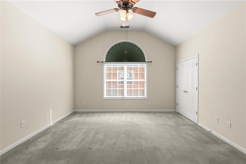 3361 Raes Creek Road, Unit 8 Marietta, GA 30008 - Photo 12 of 27 an empty room with a ceiling fan and window