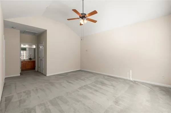 an empty room with a ceiling fan and a window