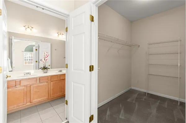 a bathroom with a double vanity sink a toilet and a shower