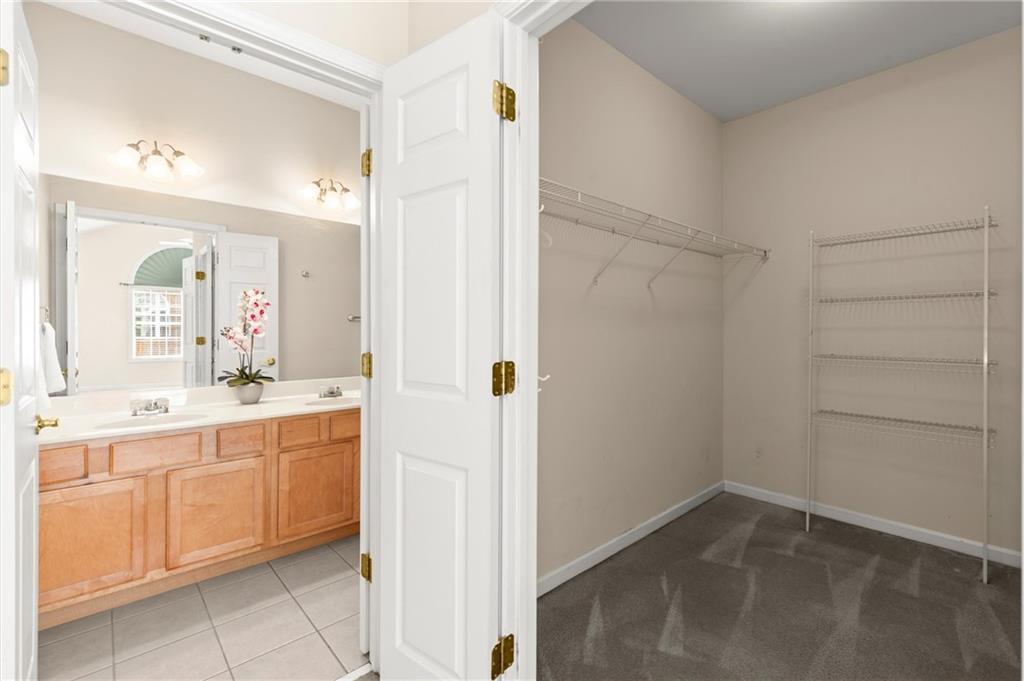 3361 Raes Creek Road, Unit 8 Marietta, GA 30008 - Photo 15 of 27 a bathroom with a double vanity sink a toilet and a shower