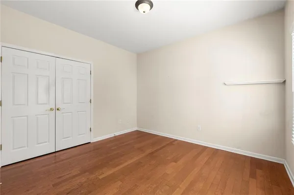 a view of a room with wooden floor
