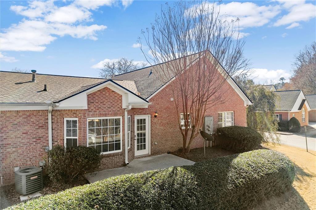3361 Raes Creek Road, Unit 8 Marietta, GA 30008 - Photo 22 of 27 a view of a house with a yard