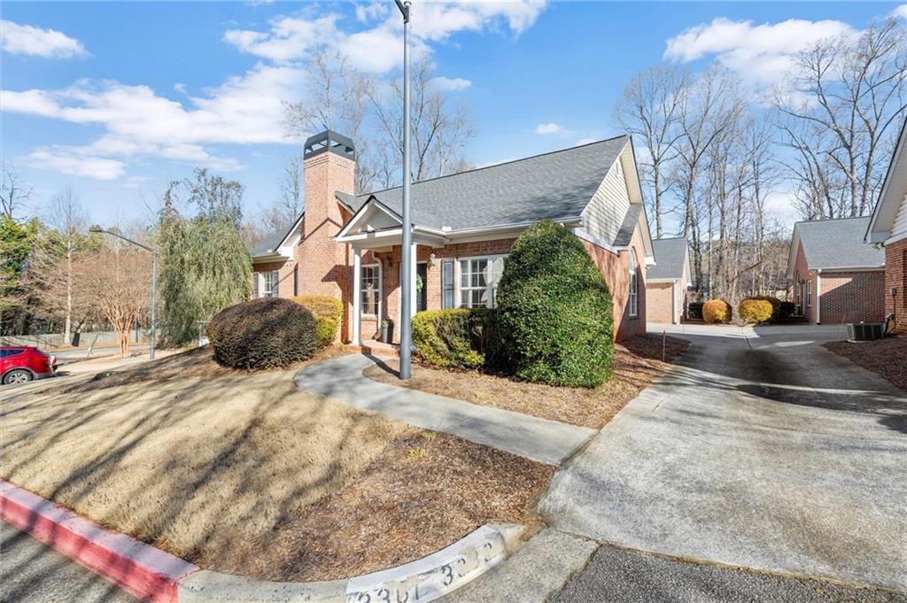 3361 Raes Creek Road, Unit 8 Marietta, GA 30008 - Photo 24 of 27 a front view of a house with a yard