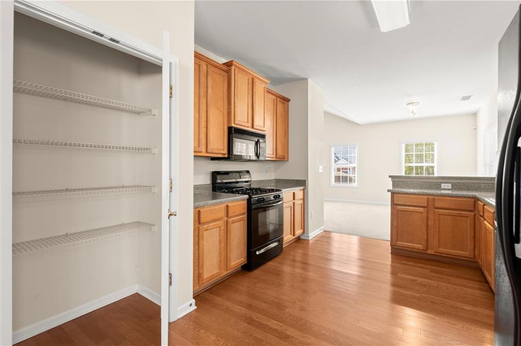 3361 Raes Creek Road, Unit 8 Marietta, GA 30008 - Photo 5 of 27 a kitchen with stainless steel appliances a stove and a refrigerator