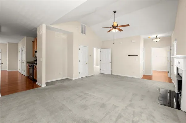 an empty room with closet and a ceiling fan