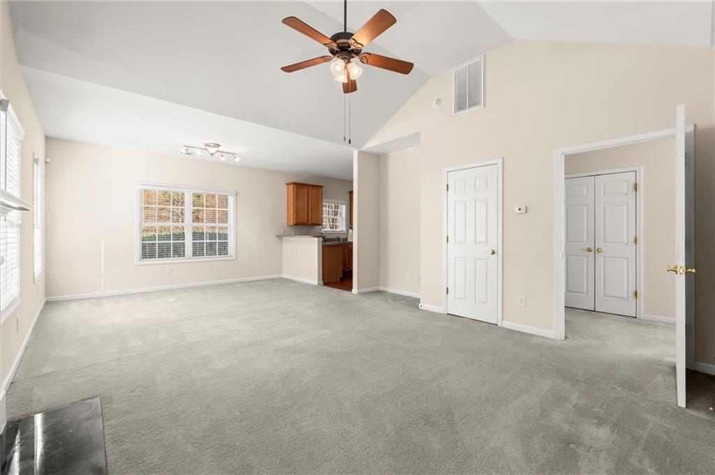 3361 Raes Creek Road, Unit 8 Marietta, GA 30008 - Photo 10 of 27 a view of a big room with windows and chandelier fan