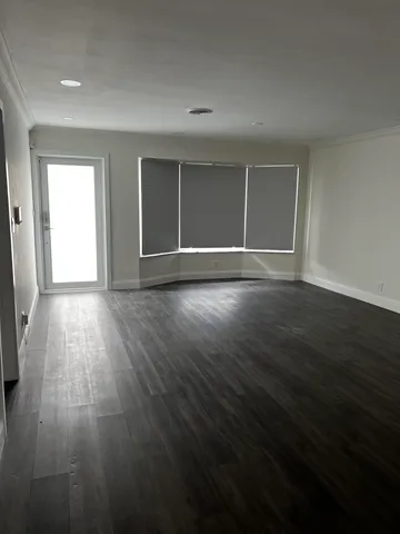a view of wooden floor and windows in a room