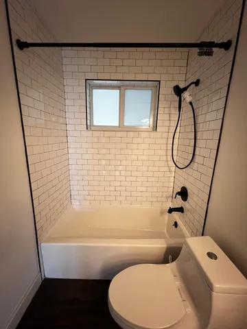 a bathroom with a toilet and a shower