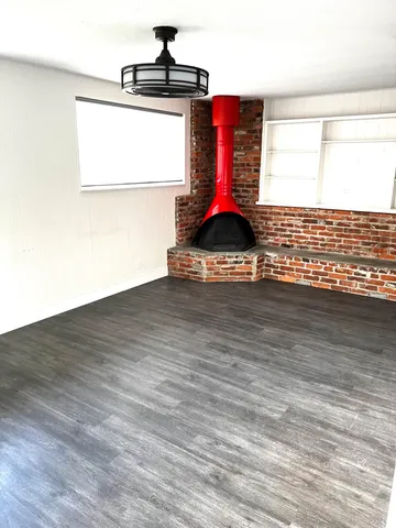 a view of a room with wooden floor and a window