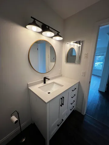 a bathroom with a double vanity sink and mirror
