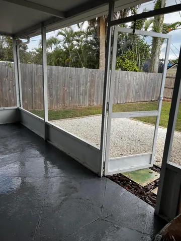 a view of a backyard with a garden and outdoor seating