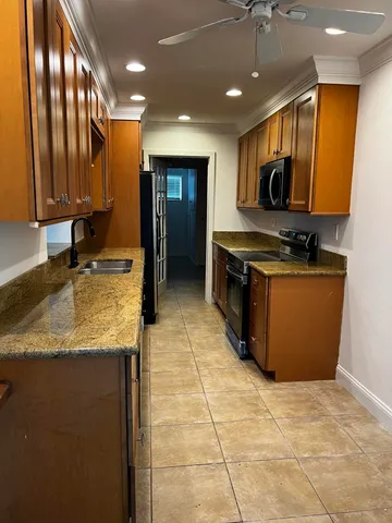 a kitchen with stainless steel appliances granite countertop a sink stove and cabinets
