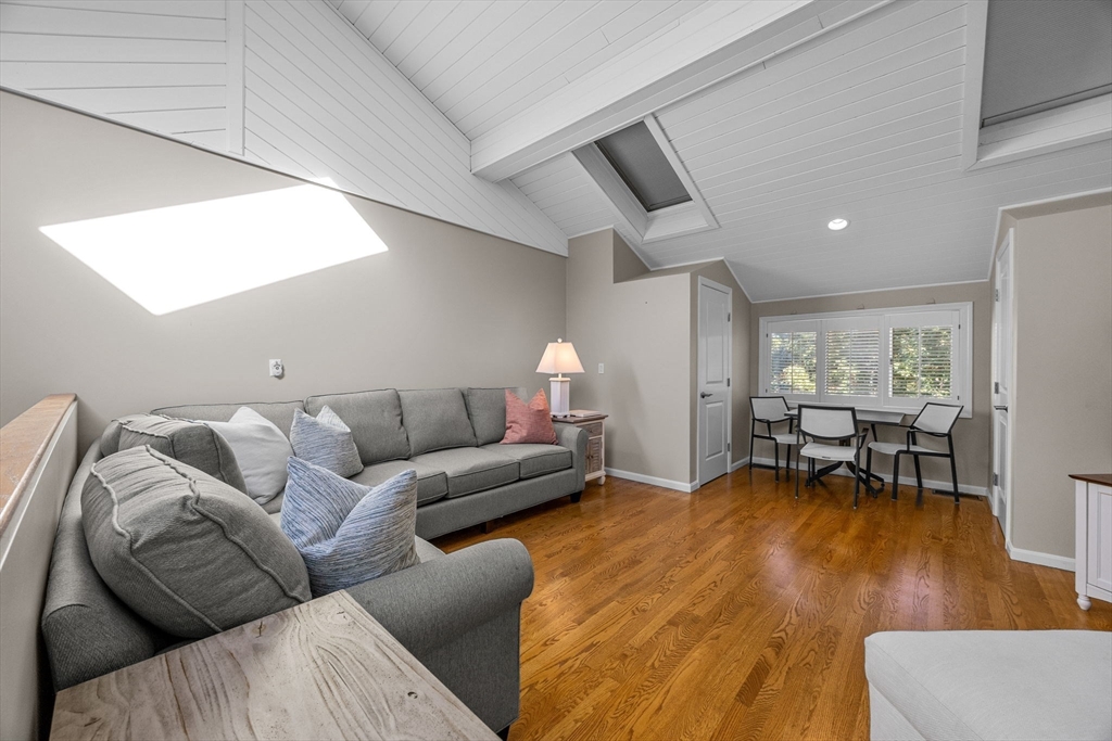 381 Great Oak Road, Unit 9 Mashpee, MA 02649 - Photo 26 of 42 a living room with furniture and a large window