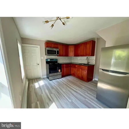 a open kitchen with cabinets and a wooden floor