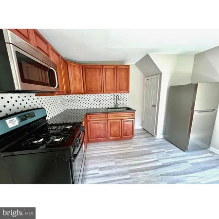 a kitchen with granite countertop a stove and a refrigerator