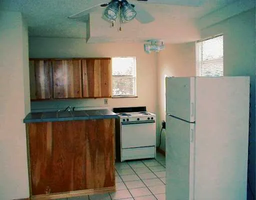 a kitchen with a refrigerator and window