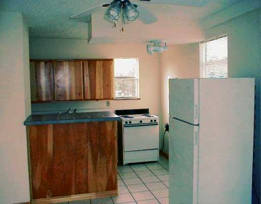 0 West Riverview Robstown, TX 78380 - Photo 2 of 4 a kitchen with a refrigerator and window
