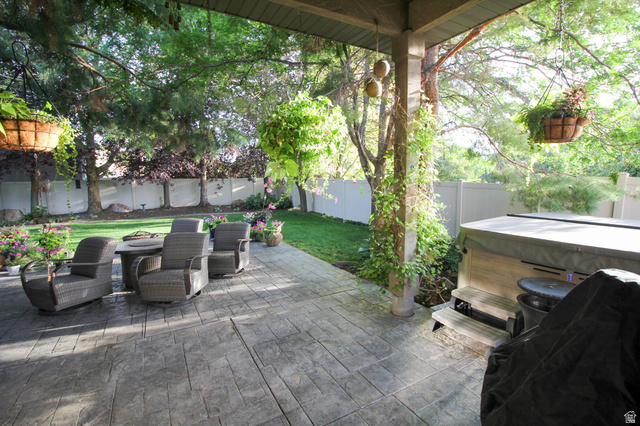 288 525 South Providence, UT 84332 - Photo 44 of 71 Fenced backyard with a hot tub and a patio area