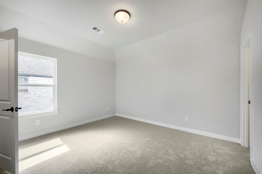 800 Blackberry Road Haslet, TX 76052 - Photo 17 of 28 This room features light gray wall paint, a single window with white trim, a flush mount ceiling light, and gray carpeting