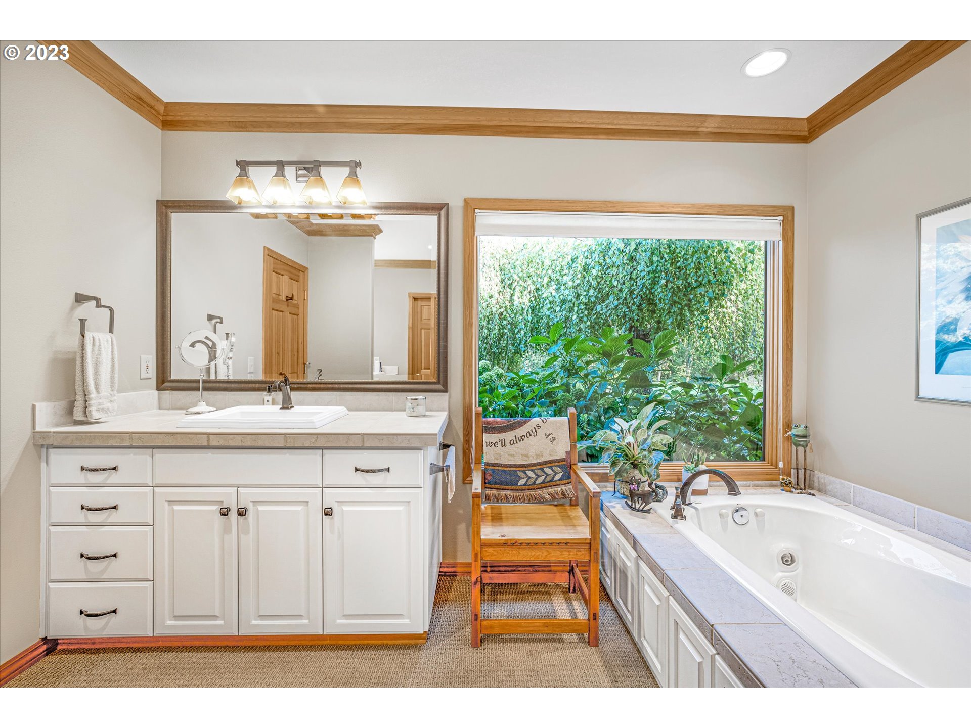 21100 South Summit Ridge Lane Oregon City, OR 97045 - Photo 22 of 32 a spacious bathroom with a granite countertop sink a large mirror and a bathtub