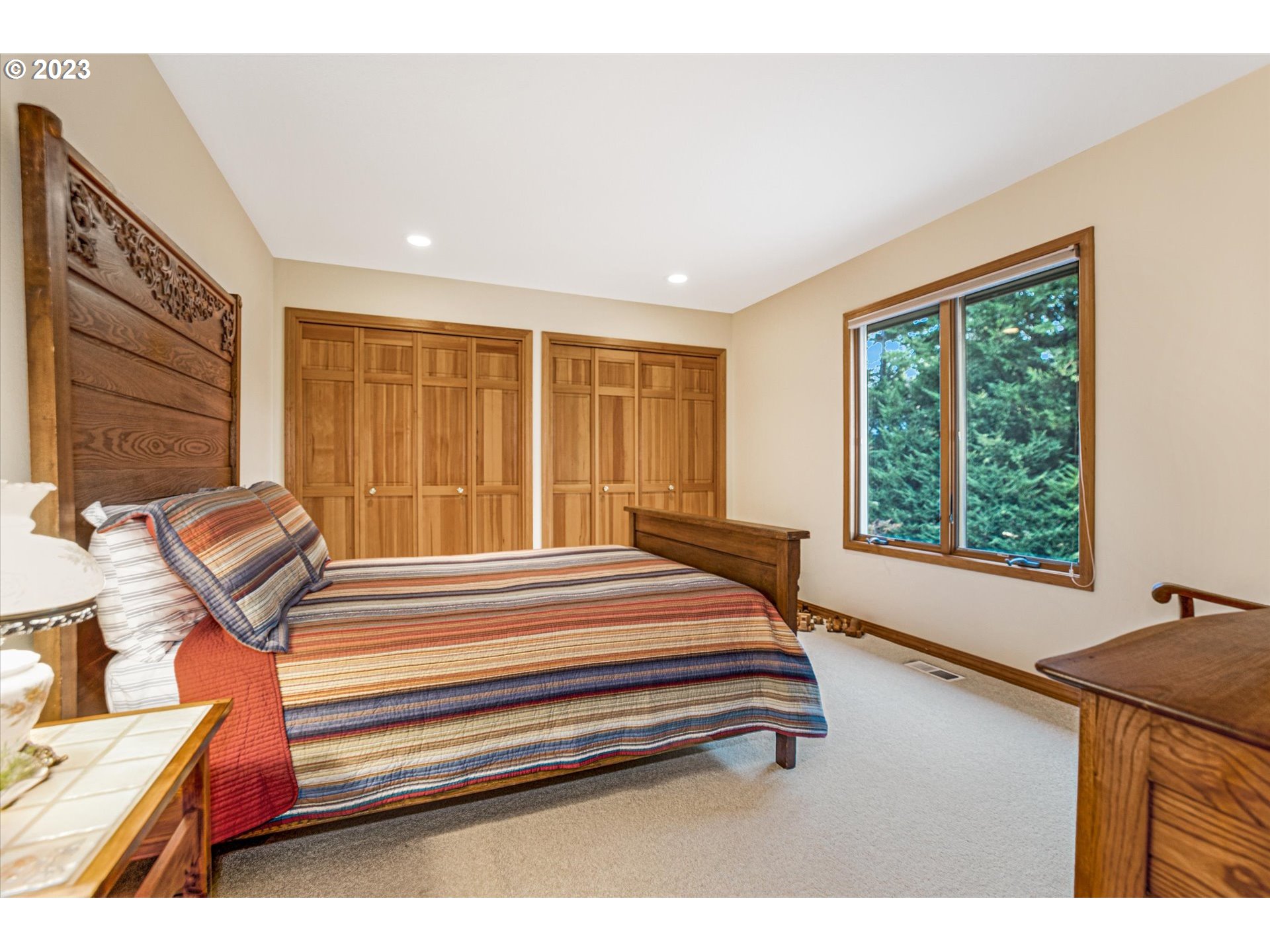 21100 South Summit Ridge Lane Oregon City, OR 97045 - Photo 28 of 32 a spacious bedroom with a bed and a large window