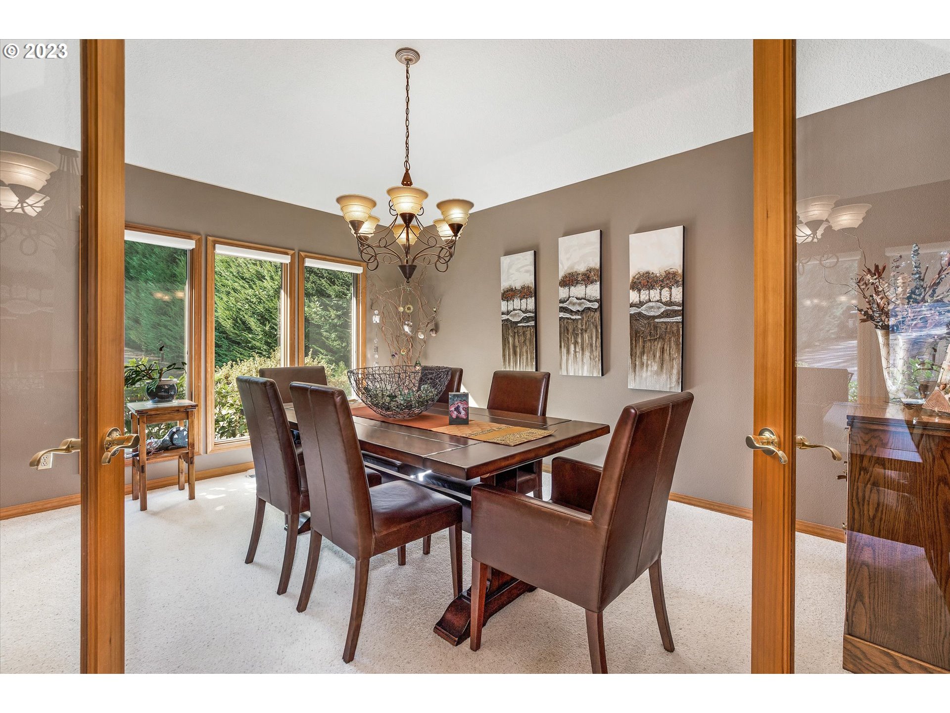 21100 South Summit Ridge Lane Oregon City, OR 97045 - Photo 6 of 32 a view of a dining room with furniture wooden floor and chandelier