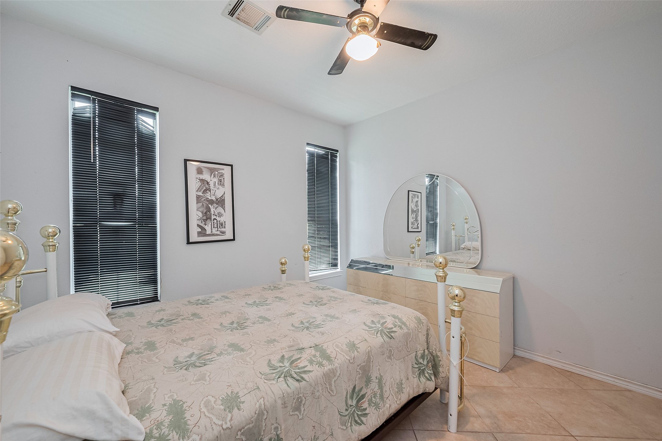 2499 Southline Road Conroe, TX 77384 - Photo 28 of 49 Spacious secondary bedroom with large windows and tile flooring.