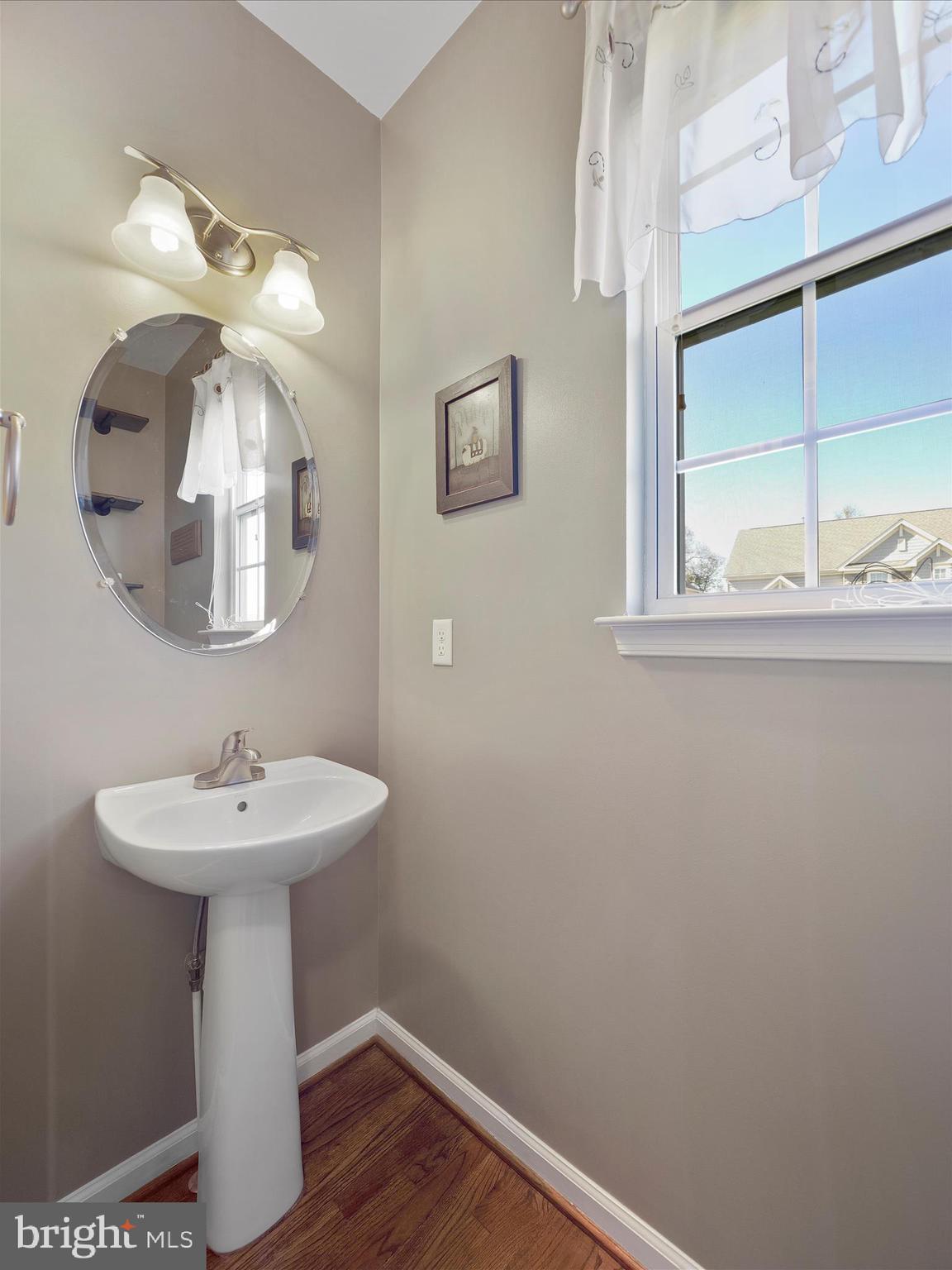 6200 Payton Way Frederick, MD 21703 - Photo 15 of 62 a bathroom with a sink a mirror and a vanity