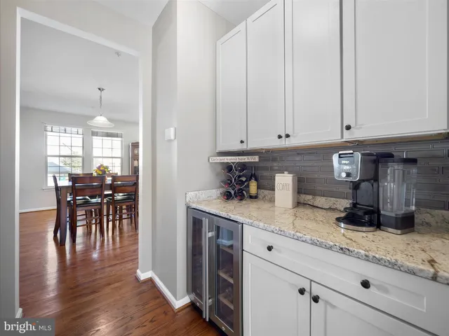 a kitchen with granite countertop a stove a sink and cabinets