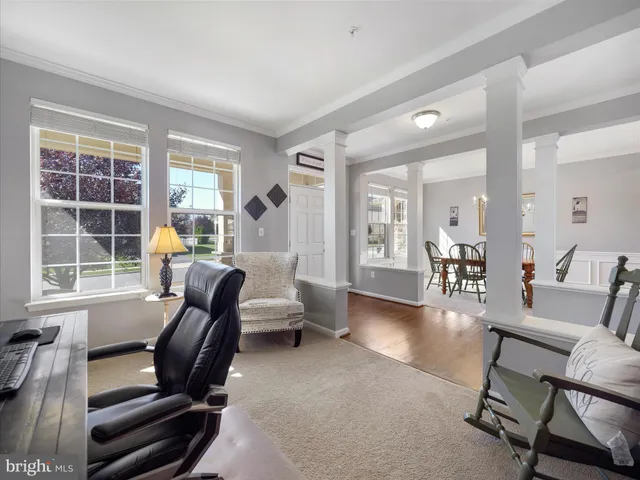 a view of a livingroom with workspace and a couch