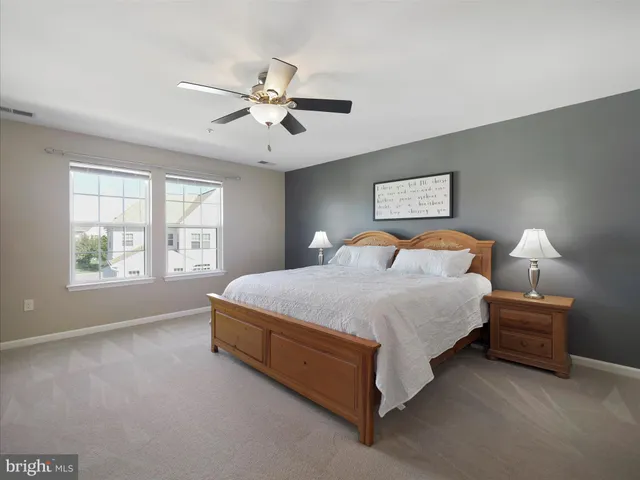 a bedroom with a bed and a ceiling fan