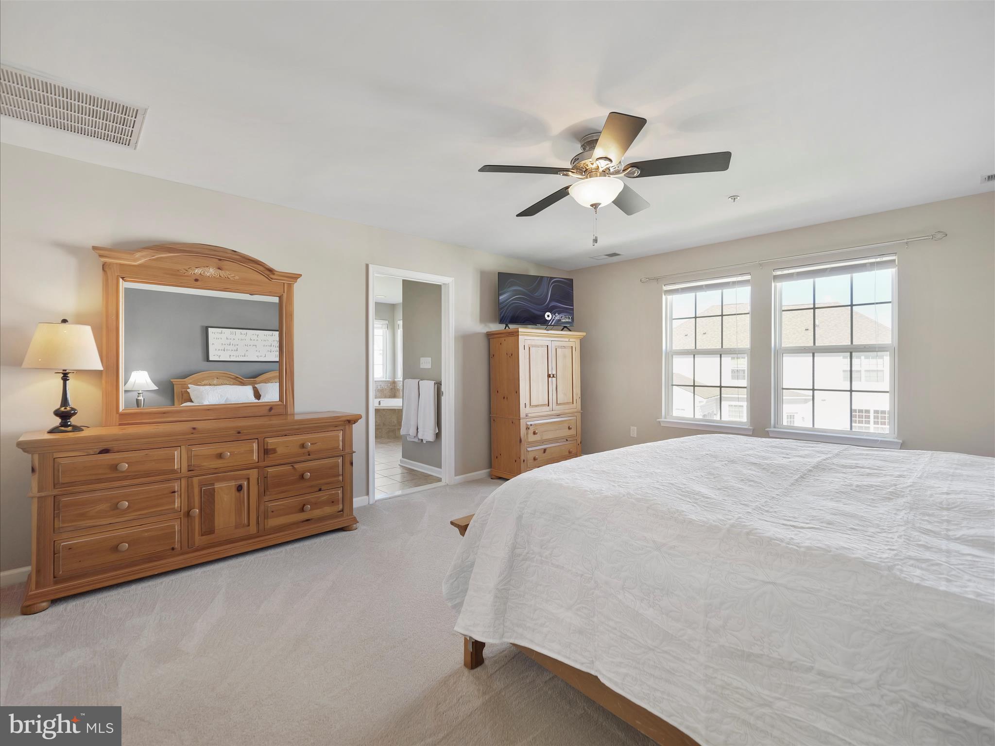 6200 Payton Way Frederick, MD 21703 - Photo 23 of 62 a bedroom with a large bed and dresser with mirror