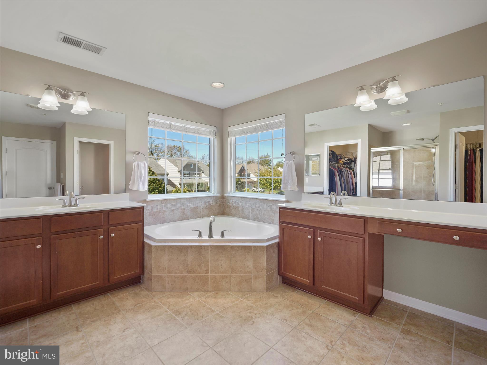6200 Payton Way Frederick, MD 21703 - Photo 24 of 62 a spacious bathroom with a tub a double vanity sink and a large mirror