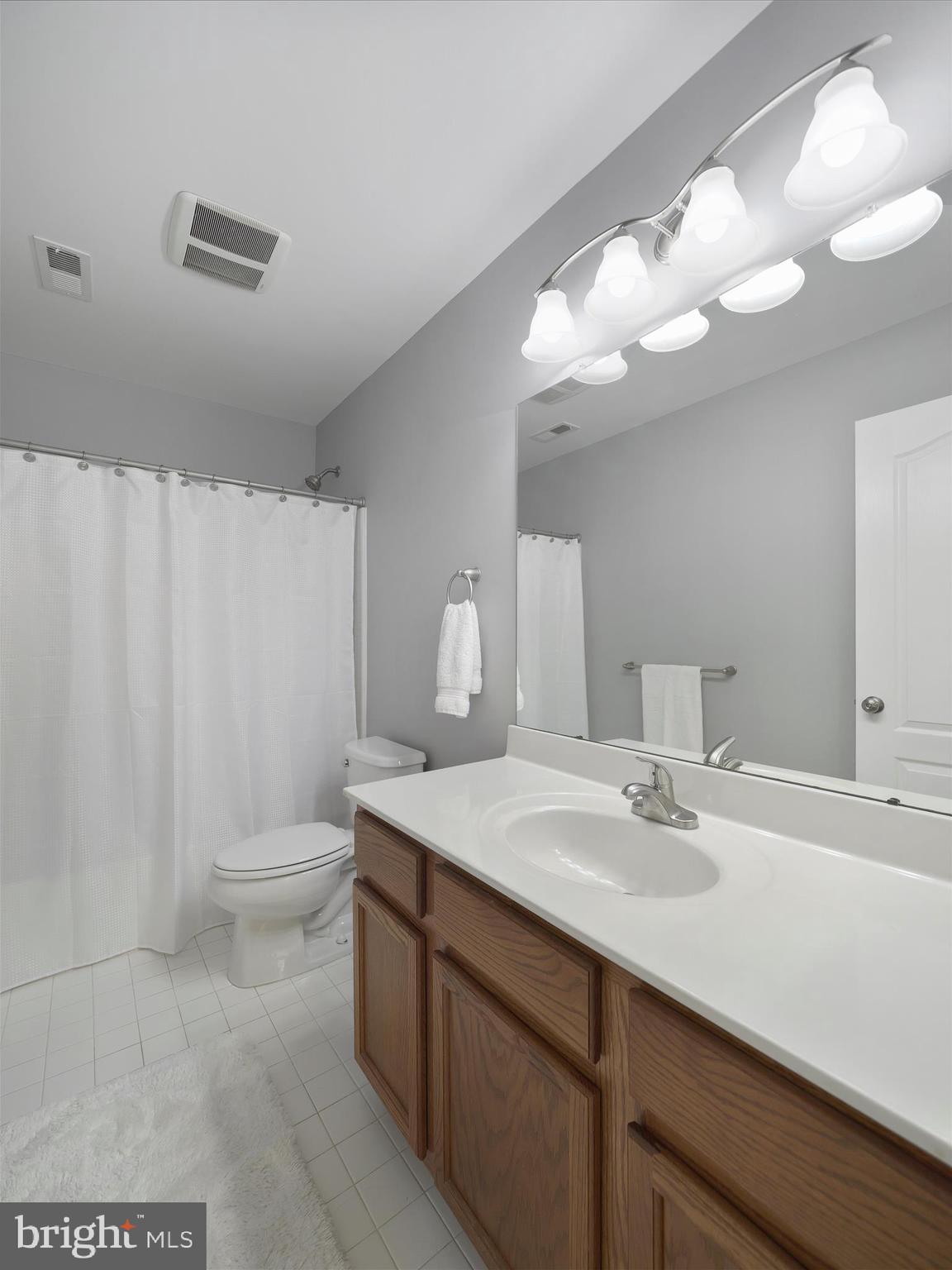 6200 Payton Way Frederick, MD 21703 - Photo 31 of 62 a bathroom with a sink vanity mirror and toilet