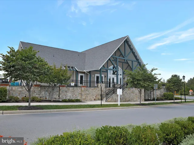 a aerial view of a house next to a yard and lake view