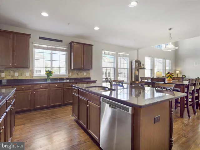 a kitchen with sink stove and cabinets