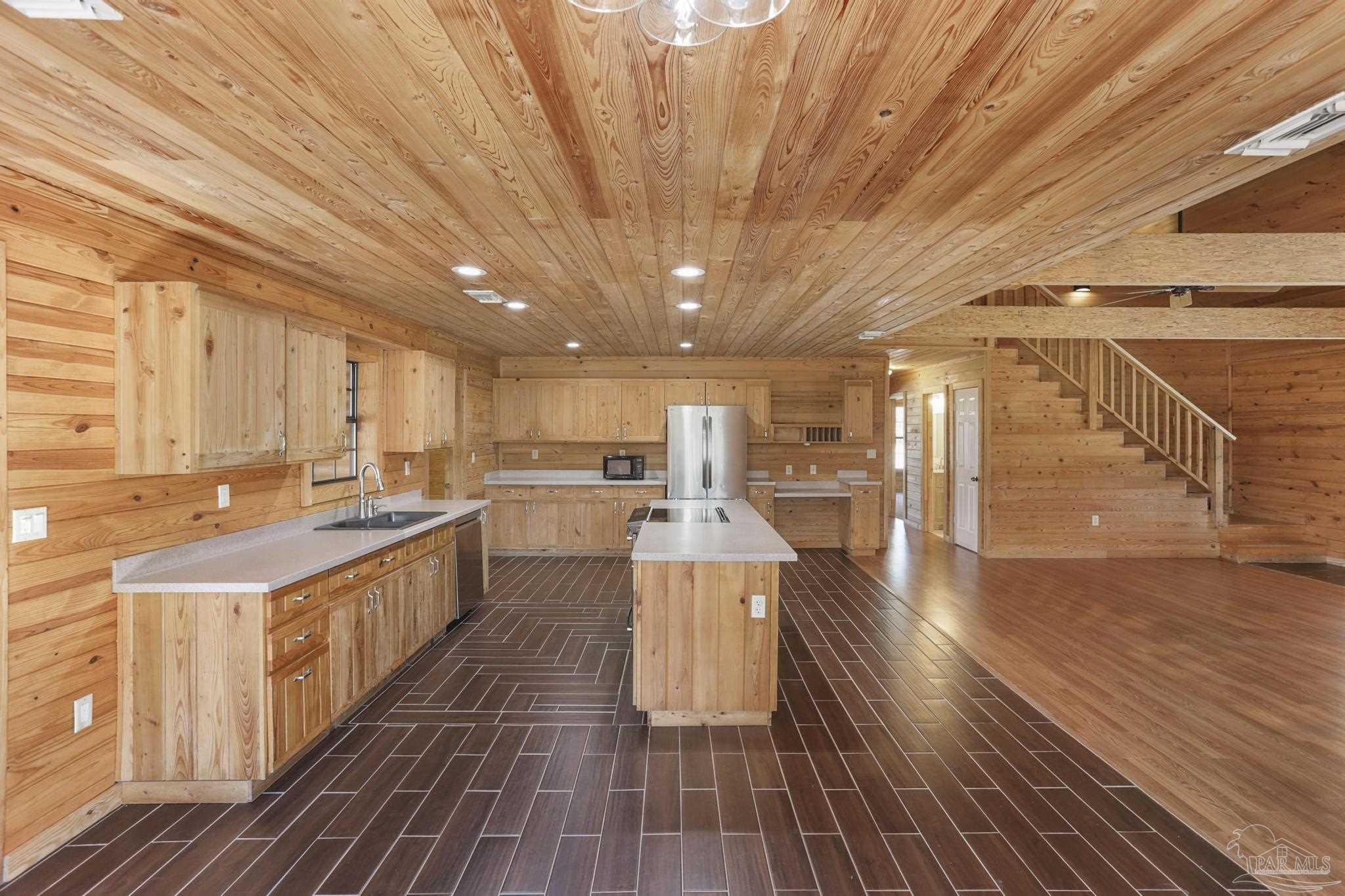 6856 Martin Road Milton, FL 32570 - Photo 11 of 50 a large kitchen with lots of counter top space and wooden floor