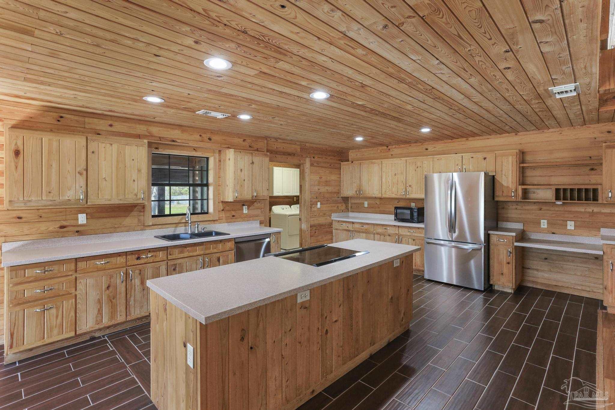 6856 Martin Road Milton, FL 32570 - Photo 15 of 50 a kitchen with refrigerator a stove a sink and a oven