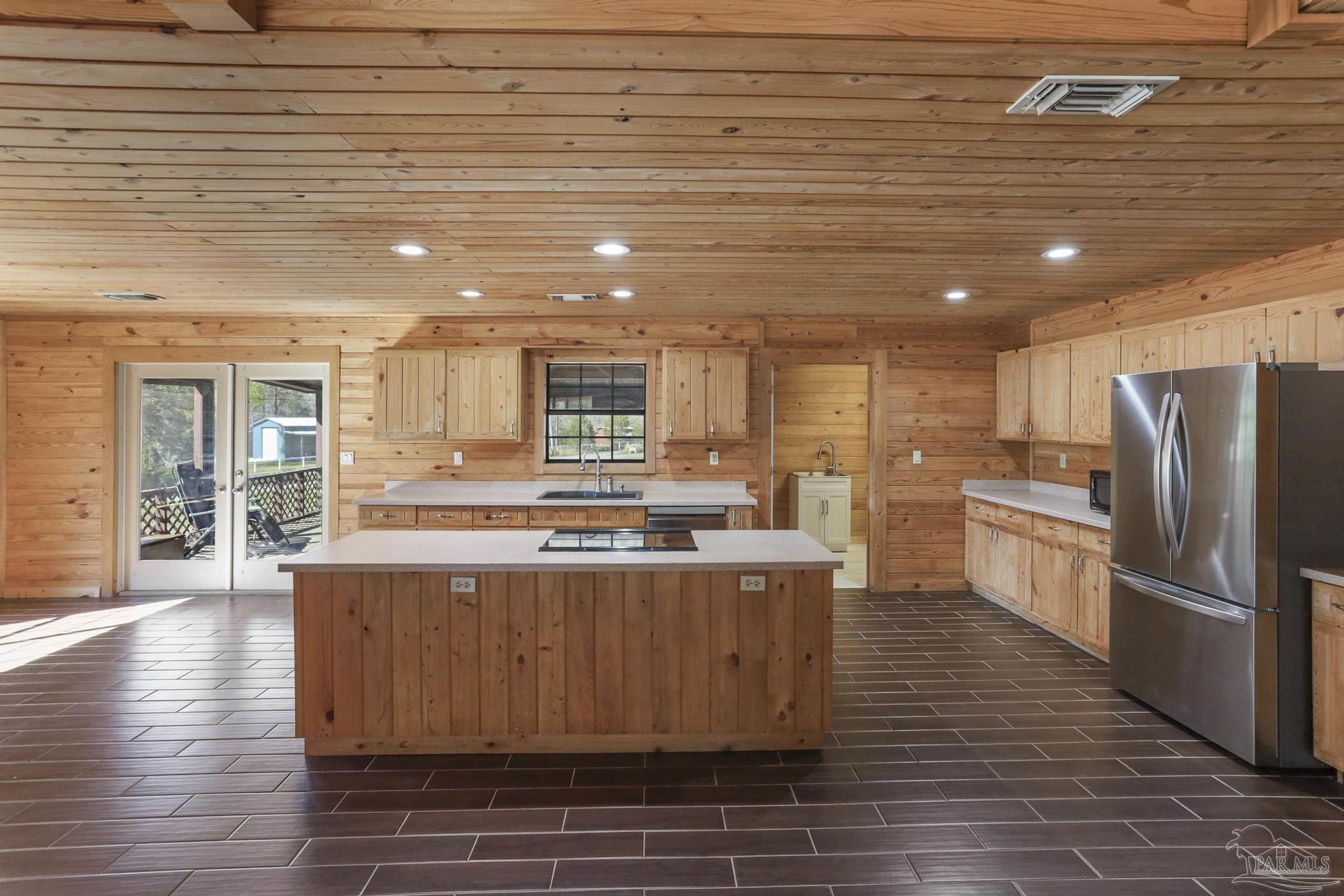 6856 Martin Road Milton, FL 32570 - Photo 16 of 50 a kitchen with stainless steel appliances granite countertop a stove and a refrigerator