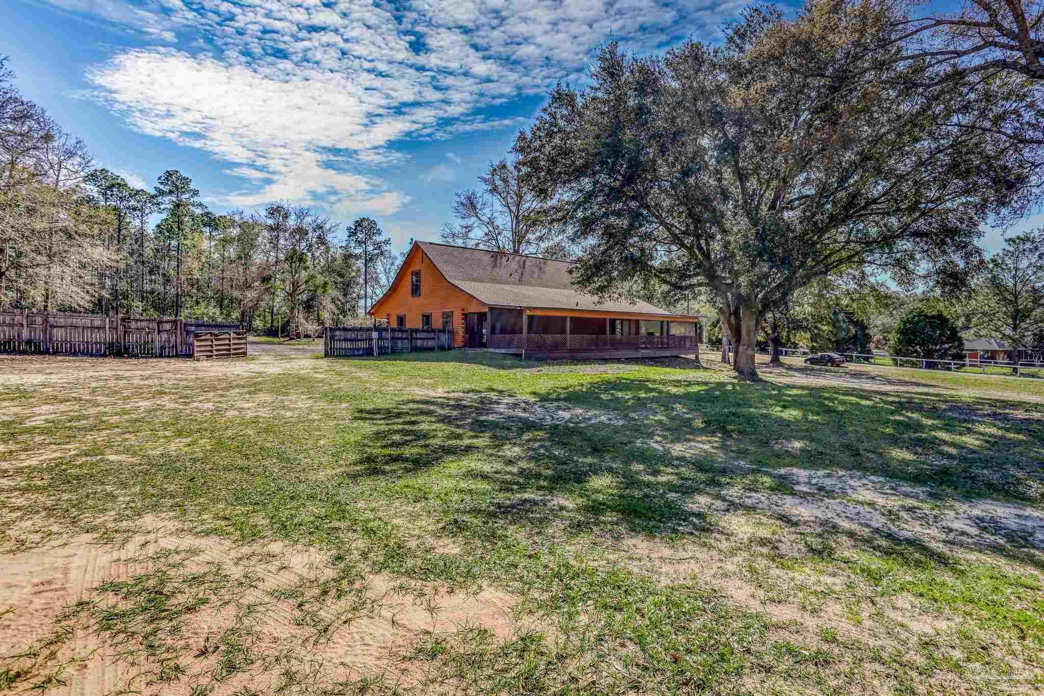 6856 Martin Road Milton, FL 32570 - Photo 36 of 50 a view of a house with a big yard and large trees