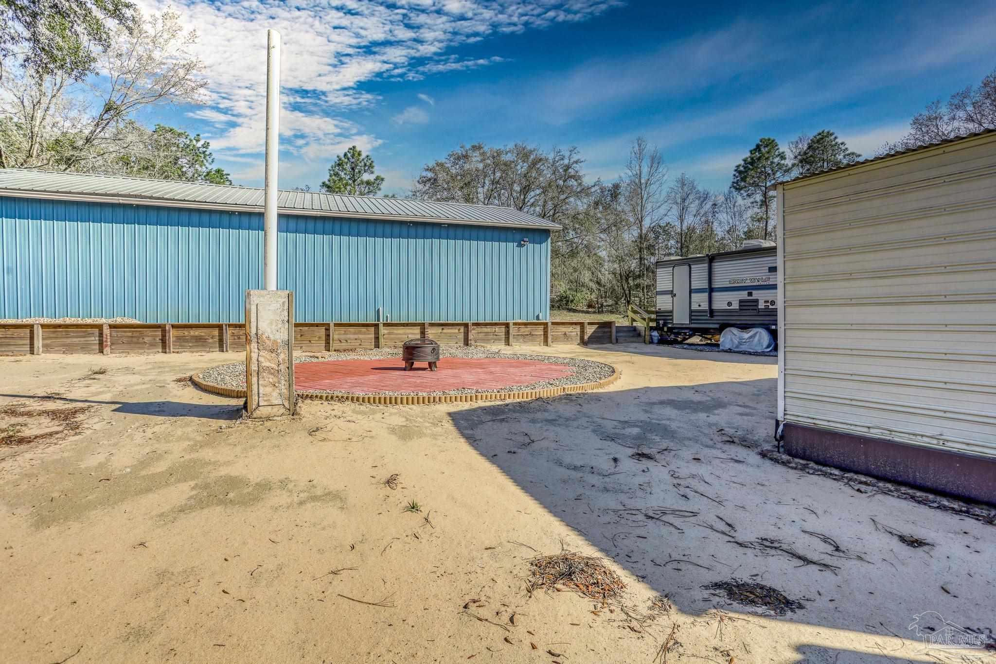 6856 Martin Road Milton, FL 32570 - Photo 41 of 50 a view of a backyard with a patio