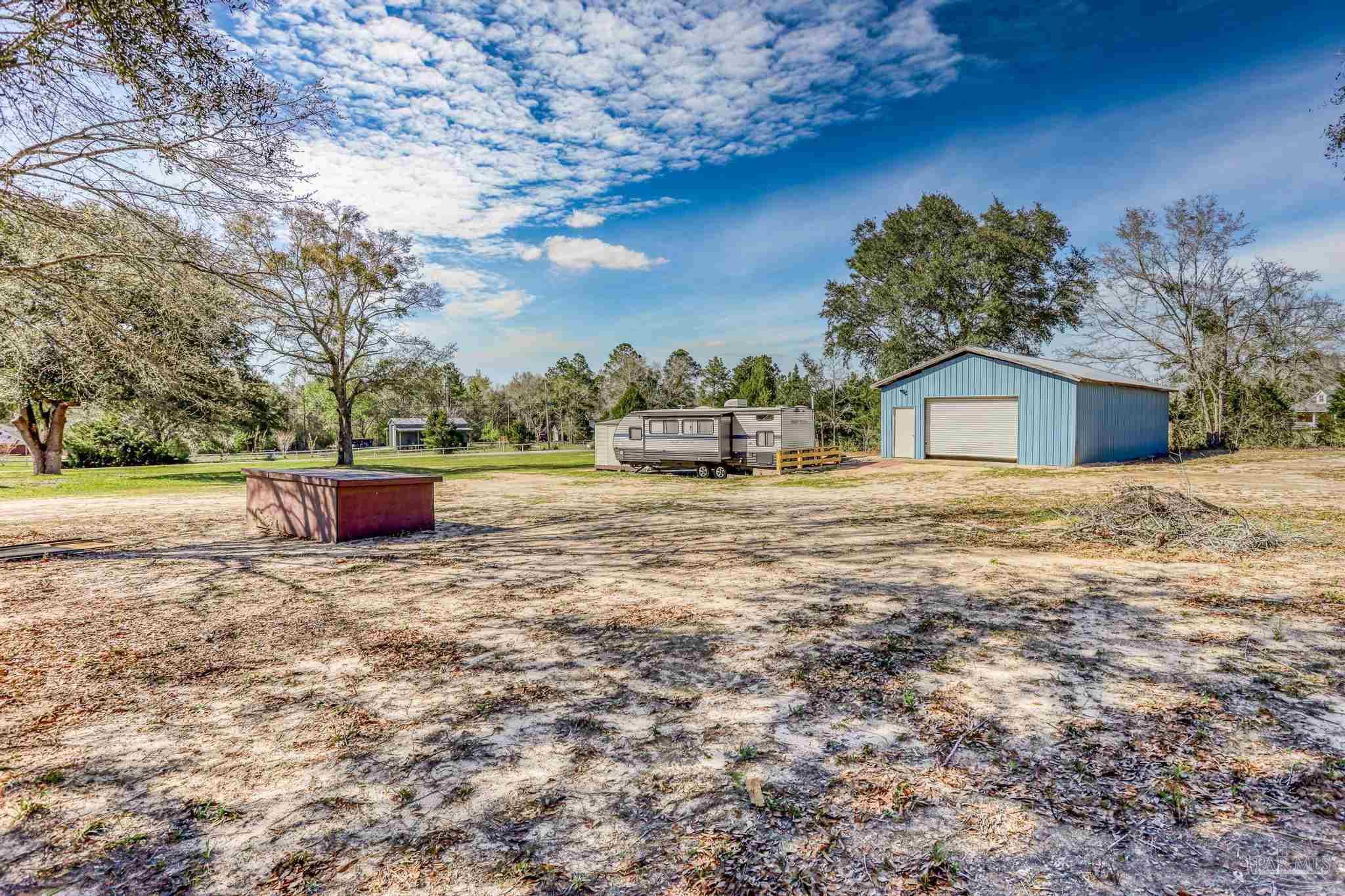 6856 Martin Road Milton, FL 32570 - Photo 43 of 50 a backyard of a house with table and chairs