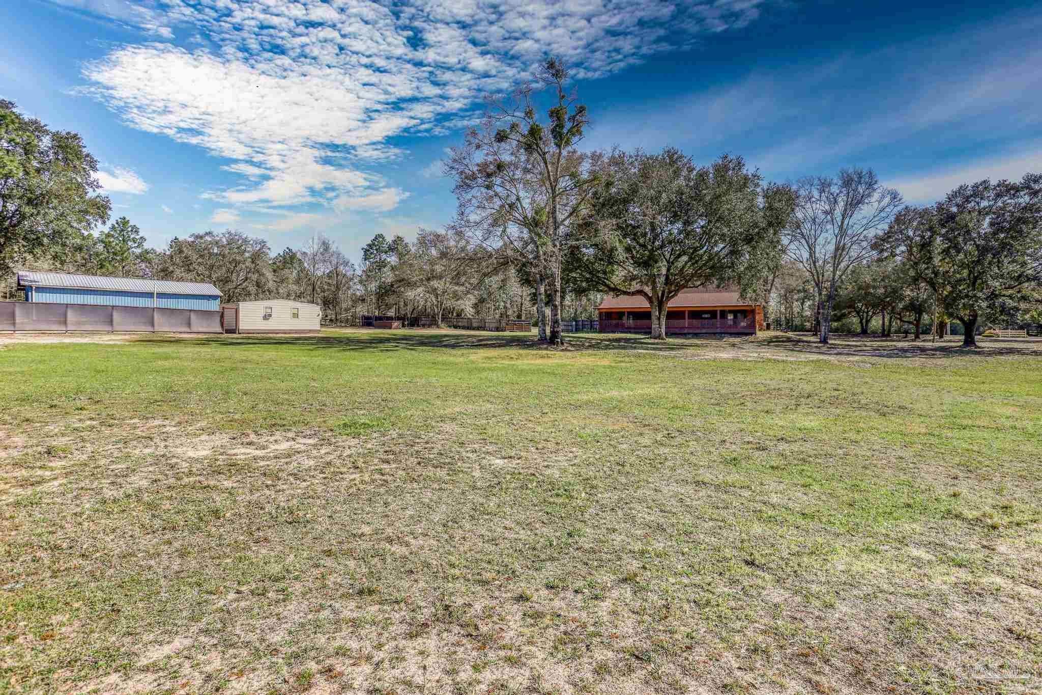 6856 Martin Road Milton, FL 32570 - Photo 44 of 50 a view of a water fountain and a big yard